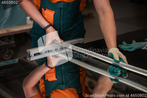 Image of Worker cutting the surface of glass mirror