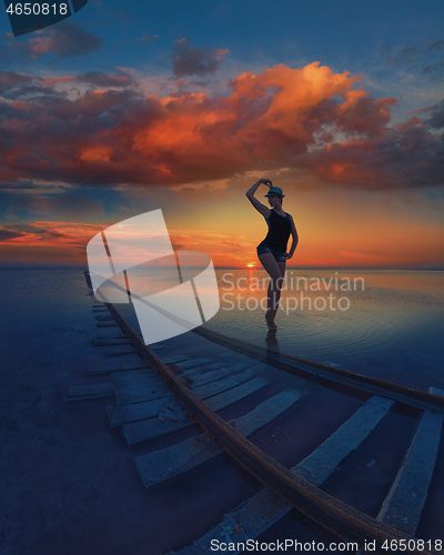 Image of Woman at beauty sunset on salty lake