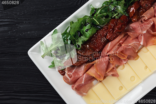 Image of prosciutto cheese and sun-dried tomatoes