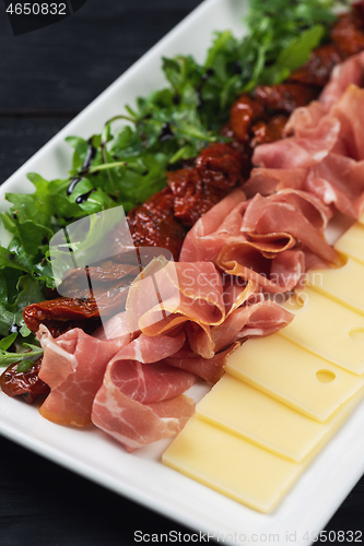 Image of prosciutto cheese and sun-dried tomatoes