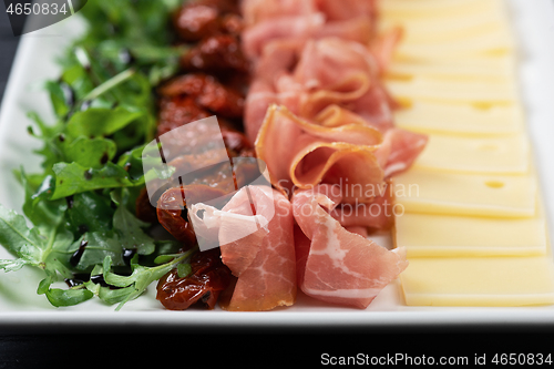 Image of prosciutto cheese and sun-dried tomatoes