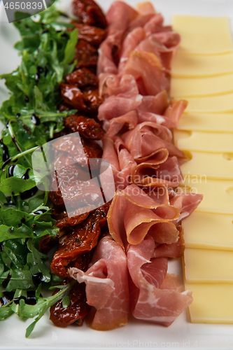 Image of prosciutto cheese and sun-dried tomatoes