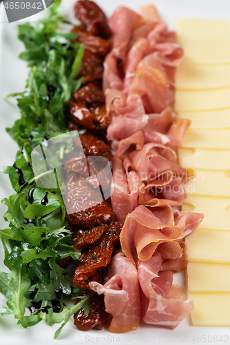 Image of prosciutto cheese and sun-dried tomatoes