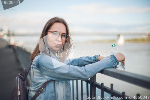 Image of Young beautiful woman staying