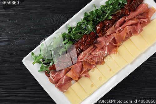 Image of prosciutto cheese and sun-dried tomatoes