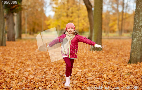 Image of happy girl running at autumn park