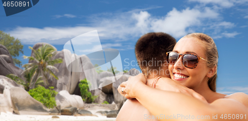 Image of happy couple hugging on summer beach