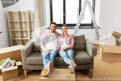 Image of happy couple with boxes moving to new home