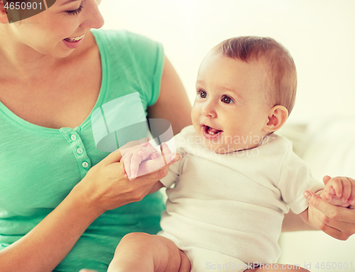 Image of happy young mother with little baby at home