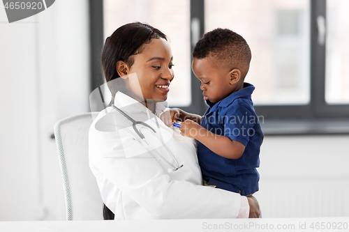 Image of doctor or pediatrician with baby patient at clinic