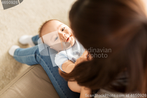 Image of young mother with little asian baby son at home