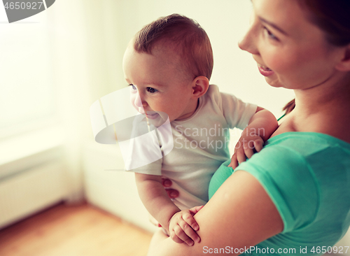 Image of happy young mother with little baby at home