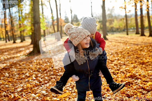 Image of happy children having fun at autumn park