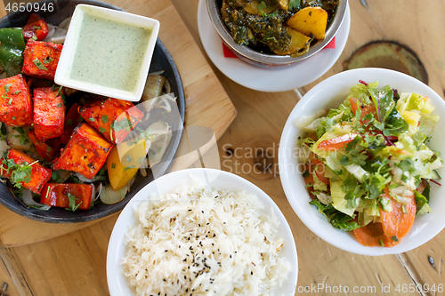 Image of various food on table of indian restaurant