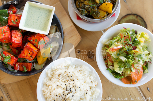Image of various food on table of indian restaurant