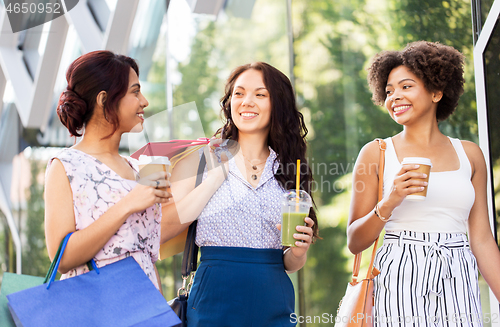 Image of women with shopping bags and drinks on city street