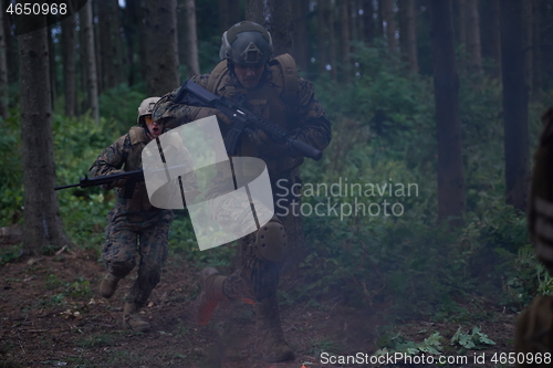 Image of Soldier in Action at Night jumping over fire