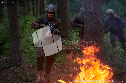 Image of Soldier in Action at Night jumping over fire