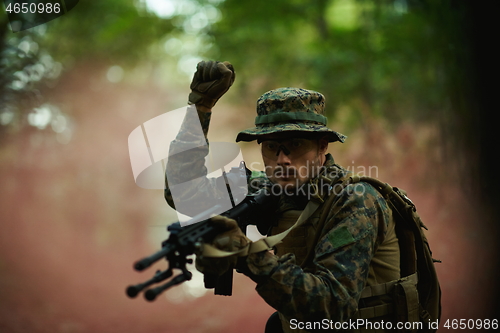 Image of officer is  showing tactical hand signals