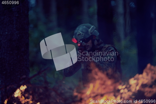 Image of soldier in action aiming  on weapon  laser sight optics