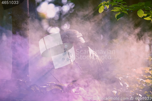 Image of soldier in action aiming  on weapon  laser sight optics