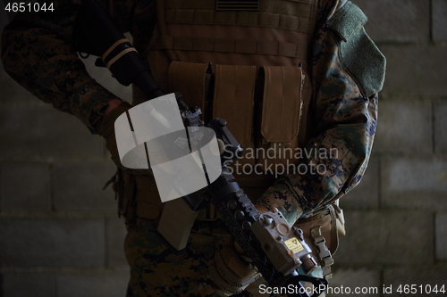 Image of soldier in action aiming  on laser sight optics