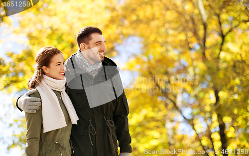 Image of smiling couple hugging in autumn park