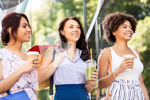 Image of women with shopping bags and drinks on city street