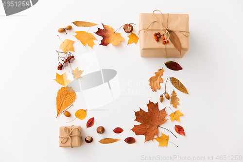 Image of frame of gifts, autumn leaves and rowanberry