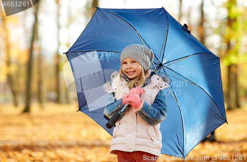 Image of happy little girl with umbrella at autumn park