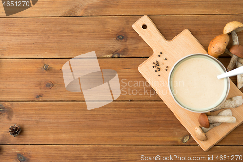 Image of mushroom cream soup in bowl on cutting board