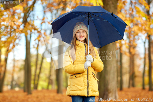 Image of happy girl with umbrella at autumn park