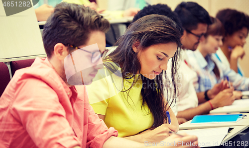 Image of group of international students writing at lecture