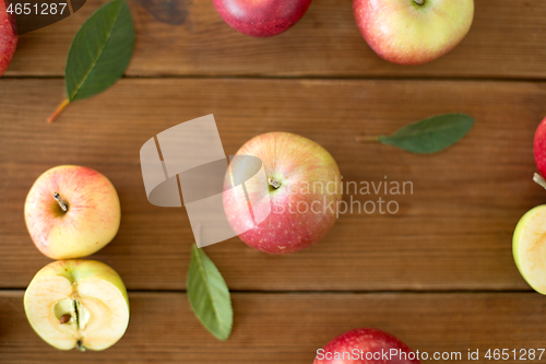 Image of ripe red apples on wooden table