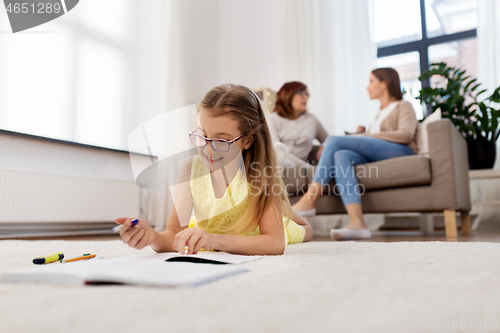 Image of student girl writing to notebook at home