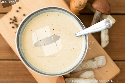 Image of mushroom cream soup in bowl on cutting board