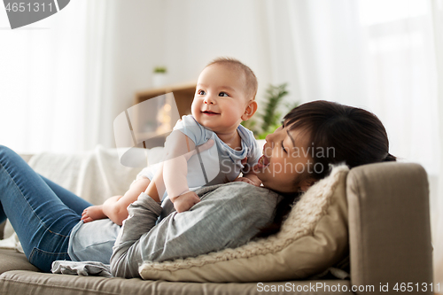 Image of happy mother with little baby son at home