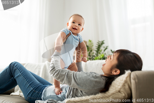 Image of happy mother with little baby son at home