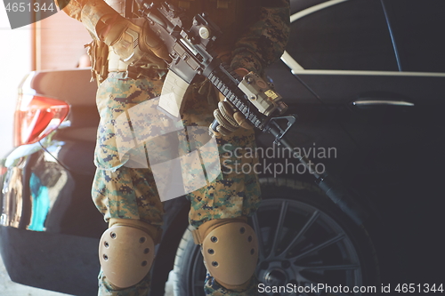 Image of soldier protecting armored luxury buletproof vehicle
