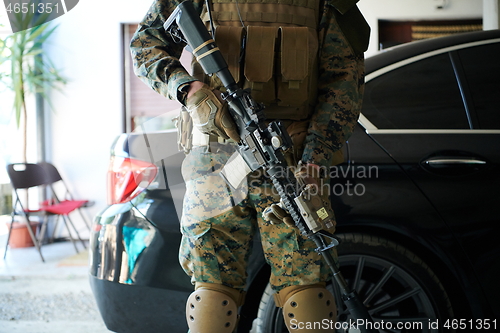 Image of soldier protecting armored luxury buletproof vehicle