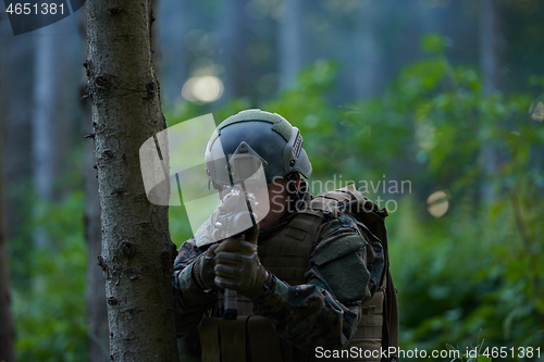 Image of soldier in action aiming  on weapon  laser sight optics