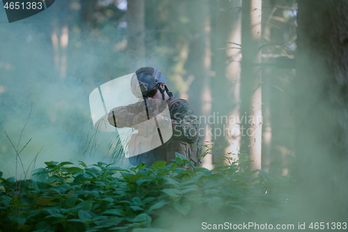 Image of soldier in action aiming  on laser sight optics