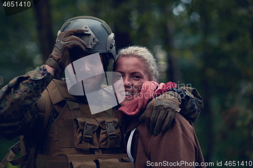 Image of soldier hugging woman