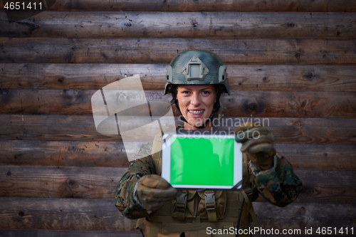 Image of woman soldier using tablet computer