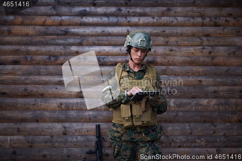 Image of woman soldier using tablet computer