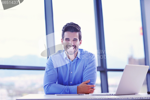 Image of happy young business man at office