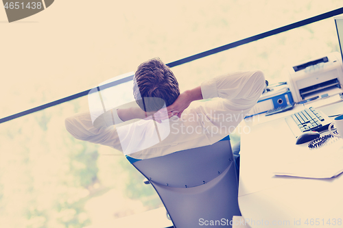 Image of happy young business man at office