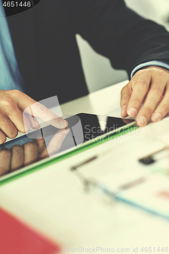 Image of business man using tablet compuer at office