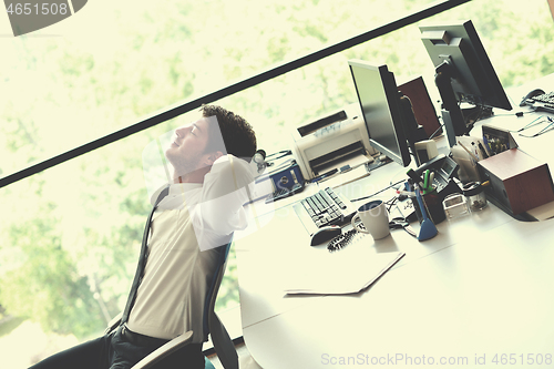 Image of happy young business man at office