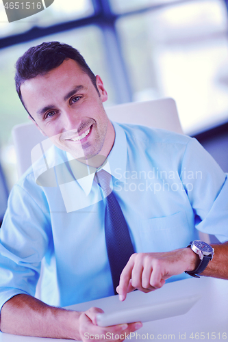Image of business man using tablet compuer at office